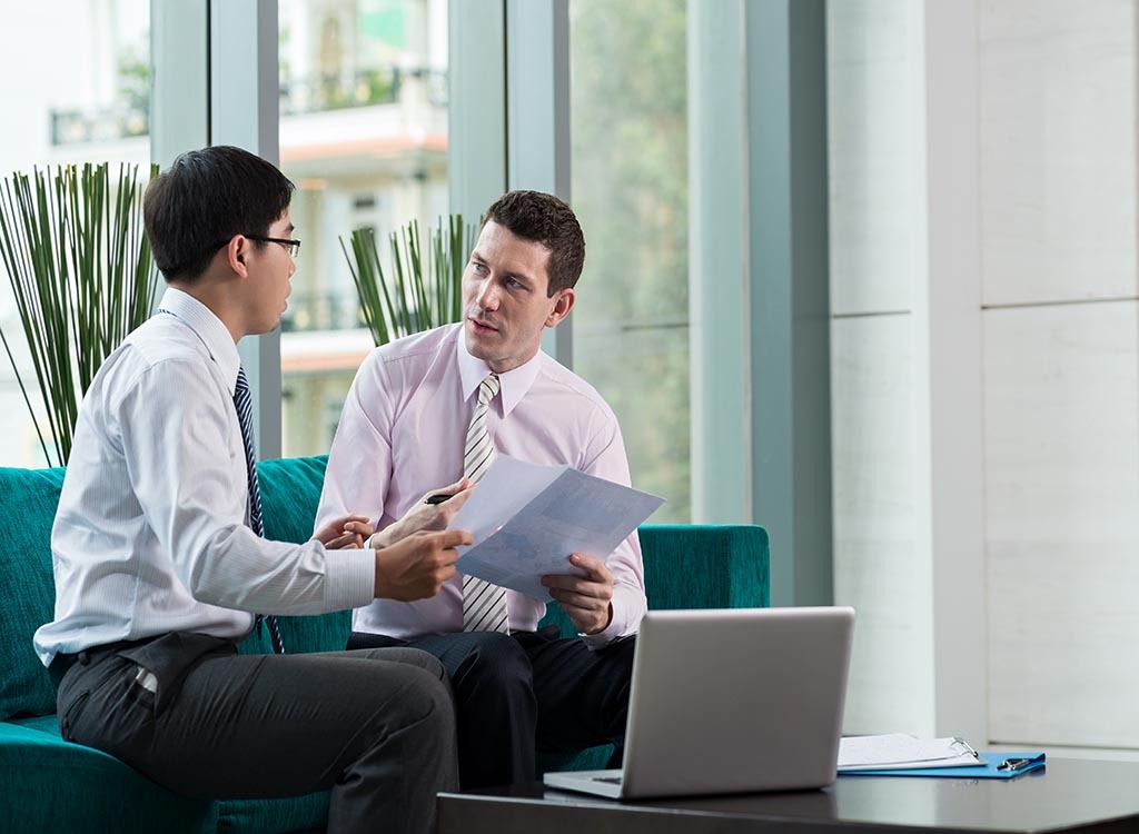 men talking at work ways to get a promotion after 40