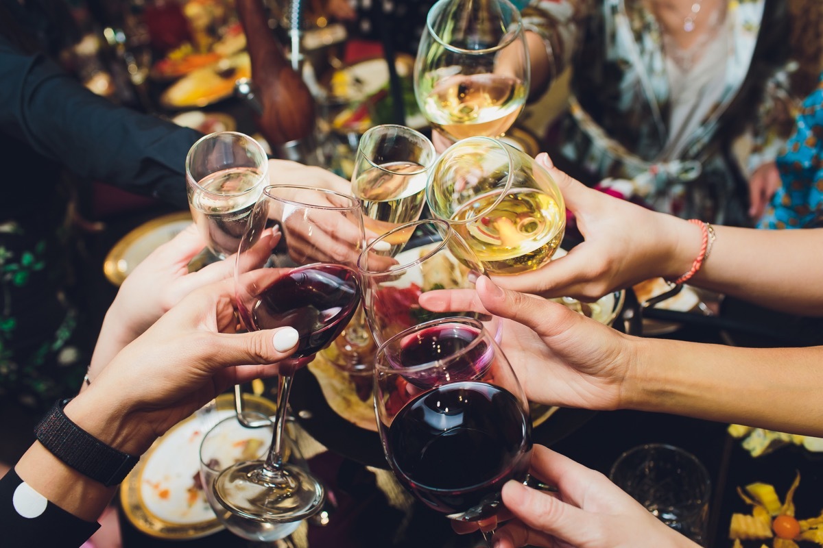 people raising their glasses in toast