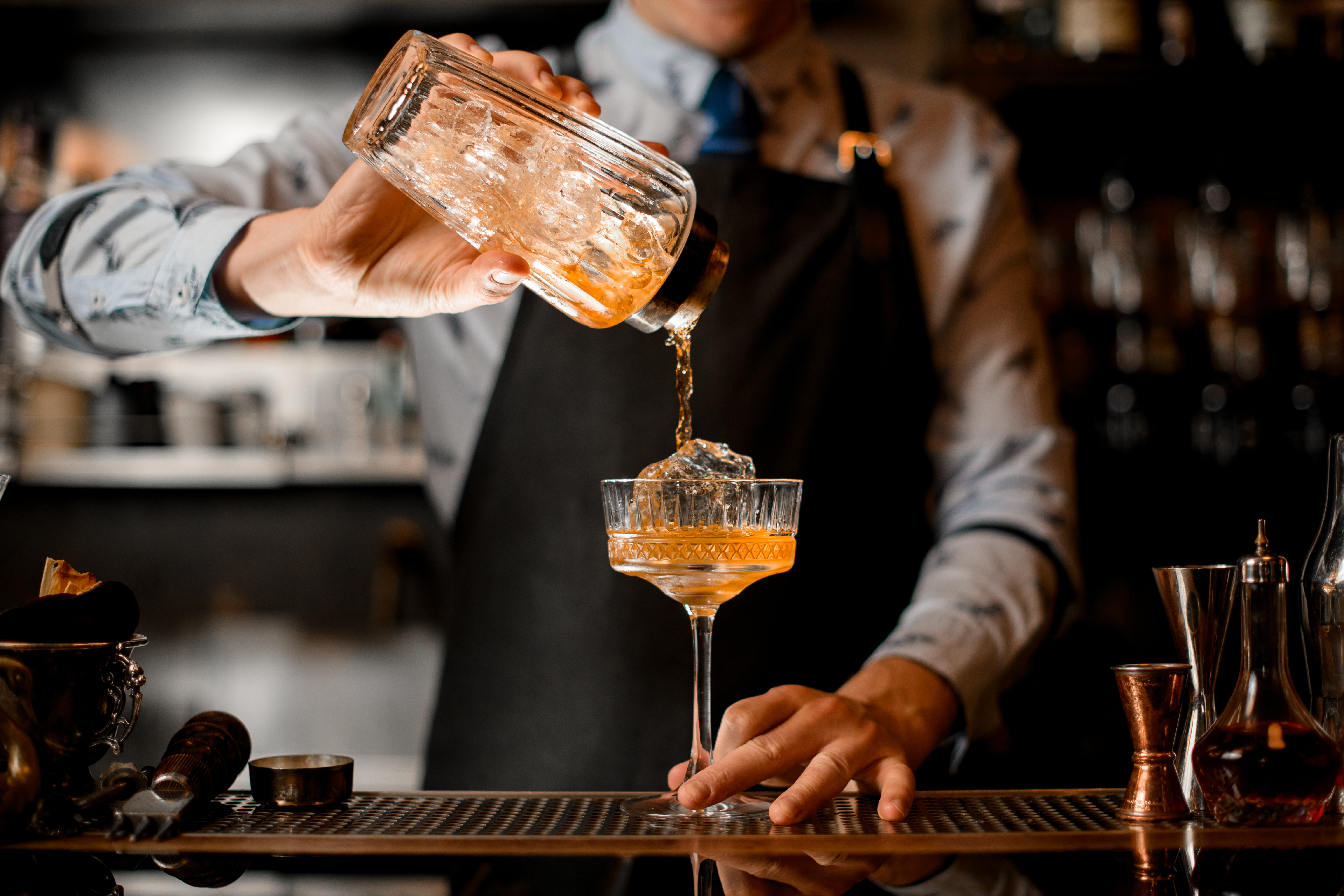 Bartender pouring a cocktail