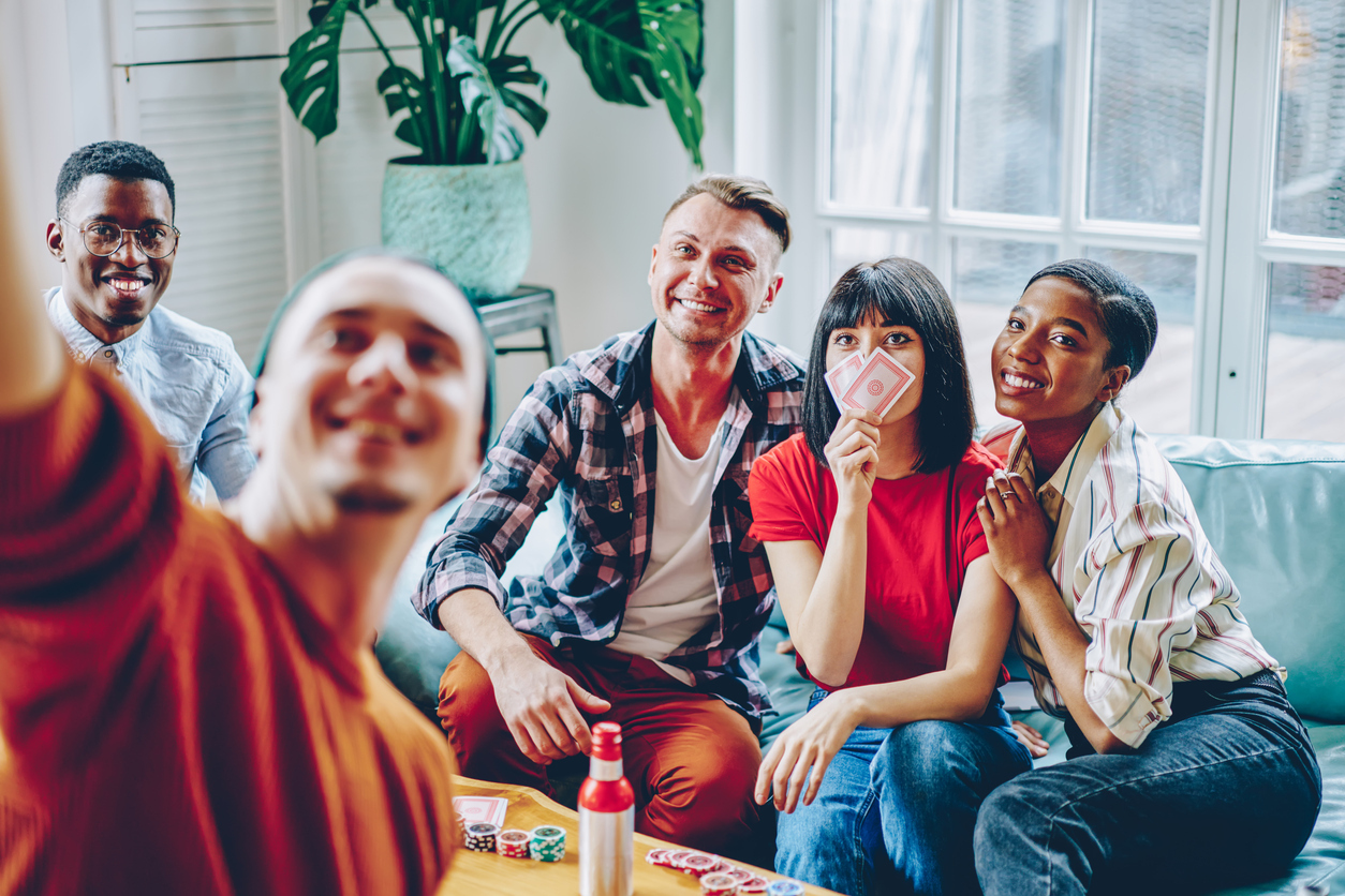 Happy multiracial friends during game night