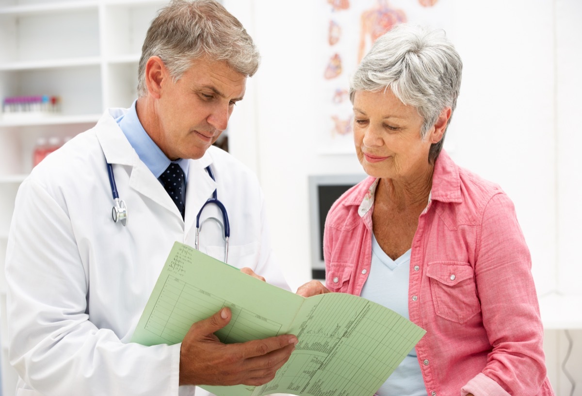 Senior woman with short gray hair talking to white male senior doctor, empty nest