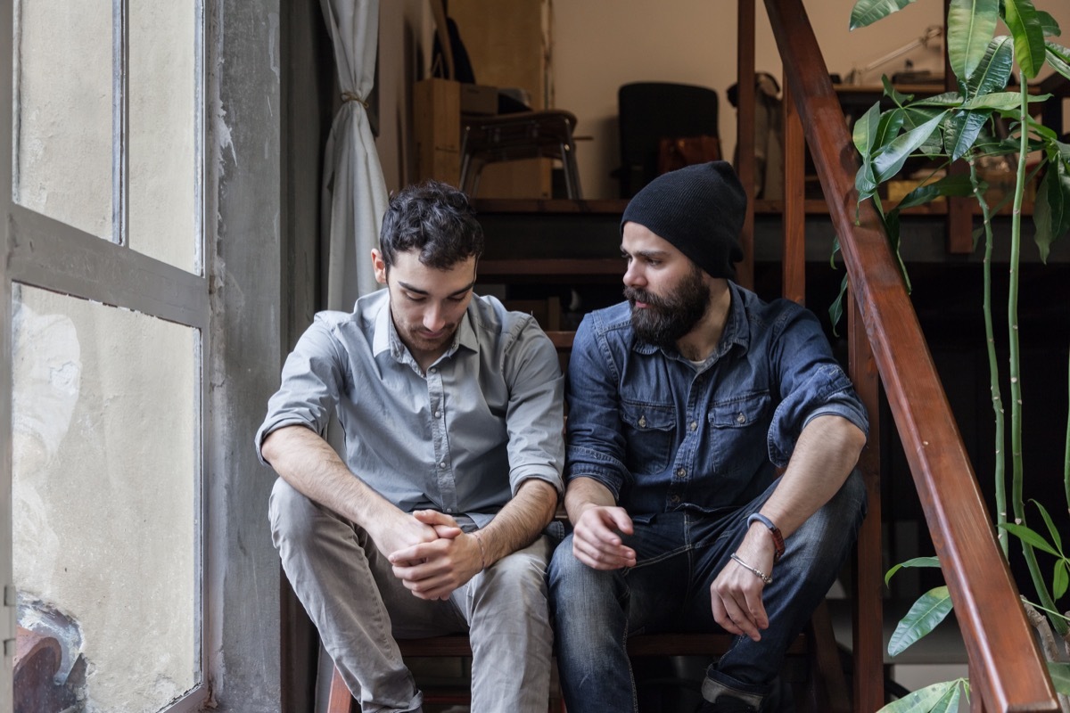 couple having serious conversation on stairs