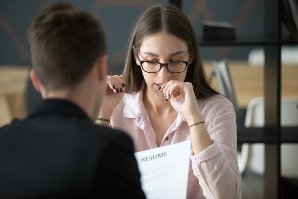 woman biting nails during a job interview