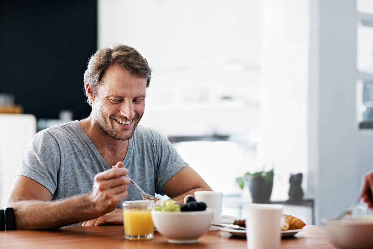 Man eating breakfast at a table.