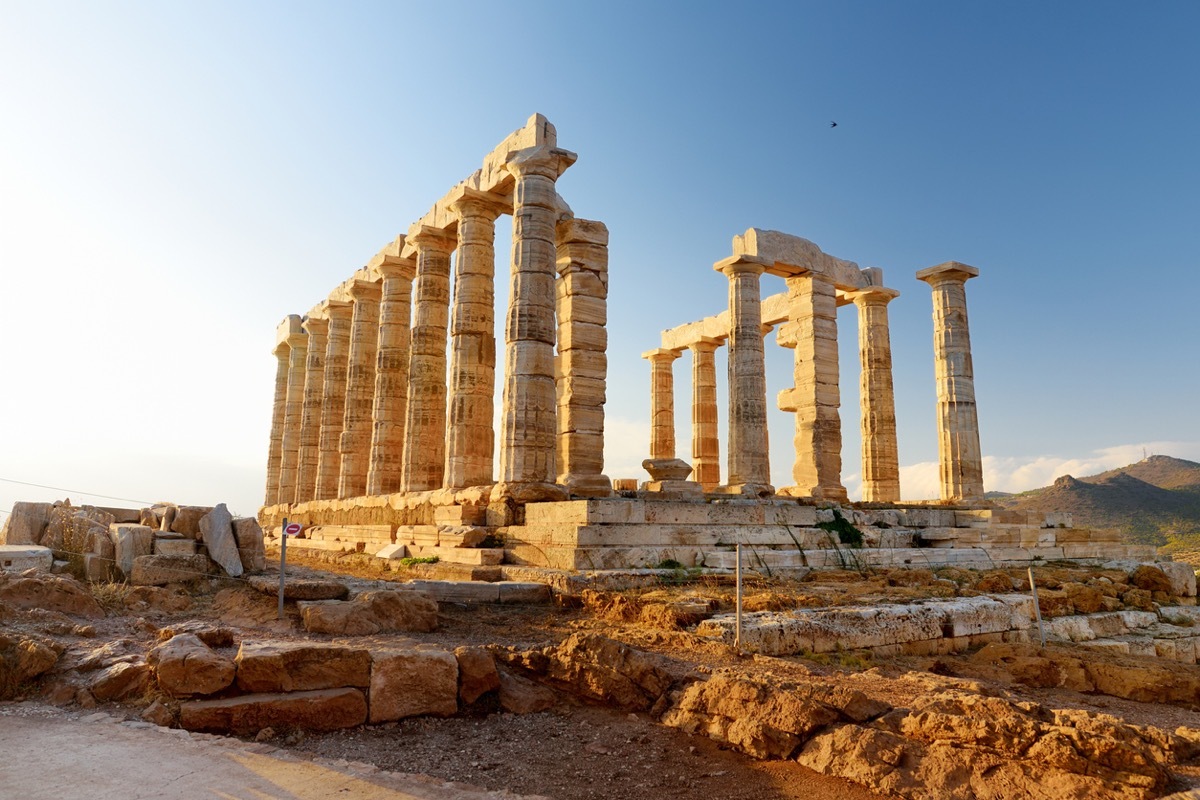 The Ancient Greek temple of Poseidon at Cape Sounion, one of the major monuments of the Golden Age of Athens. Scenic temple ruins with Doric-style columns, offering sweeping views of the sea.