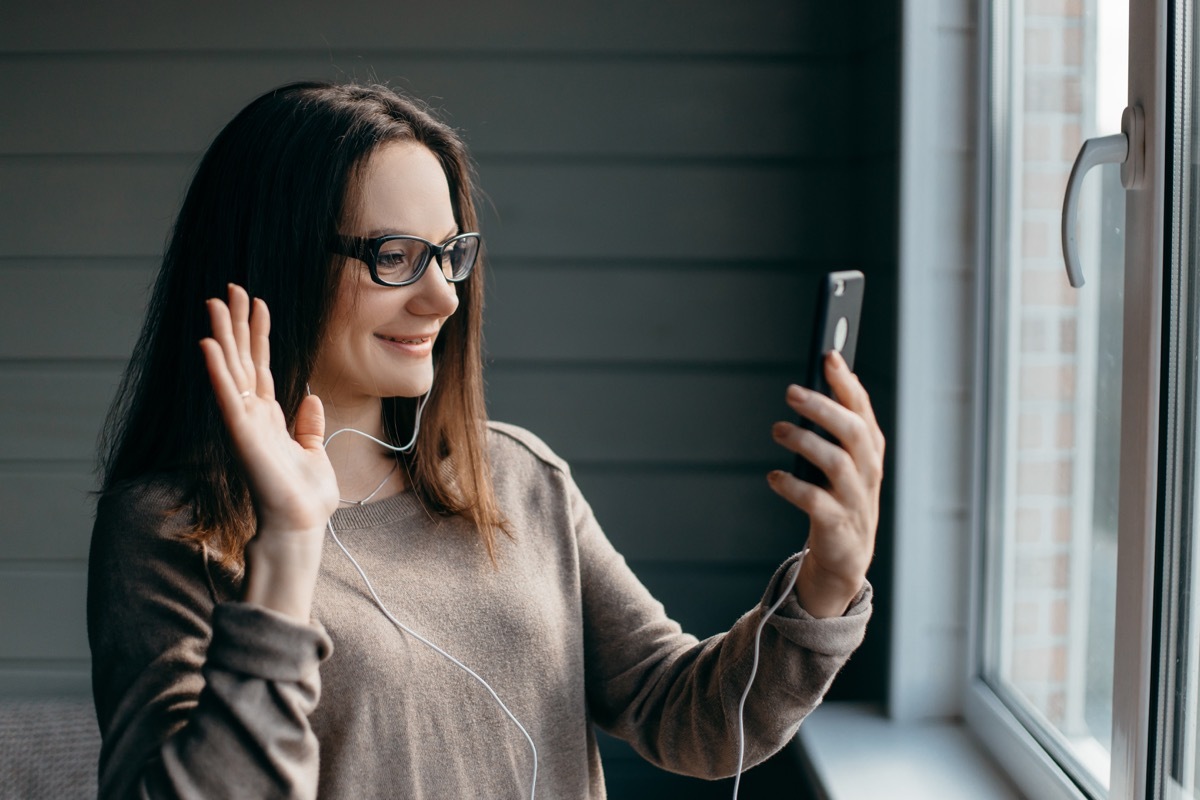 Woman doing a video chat while standing