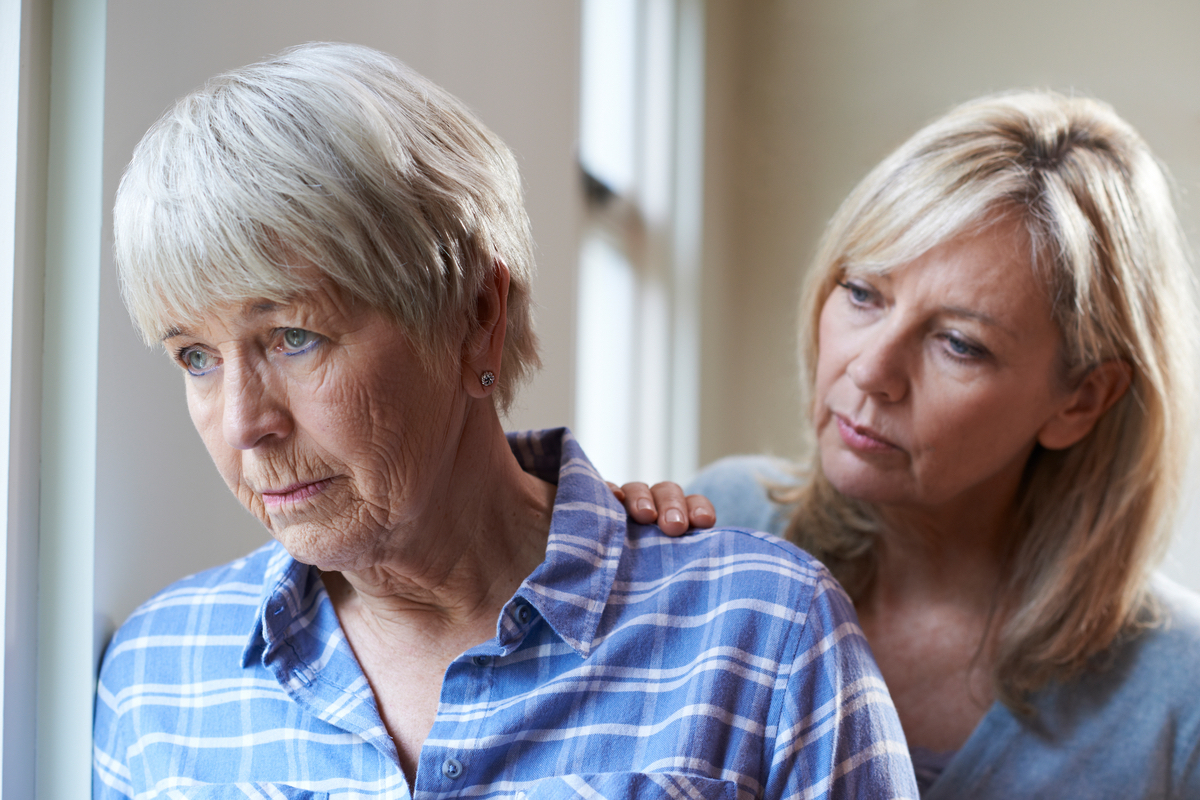 Serious Senior Woman With Adult Daughter At Home