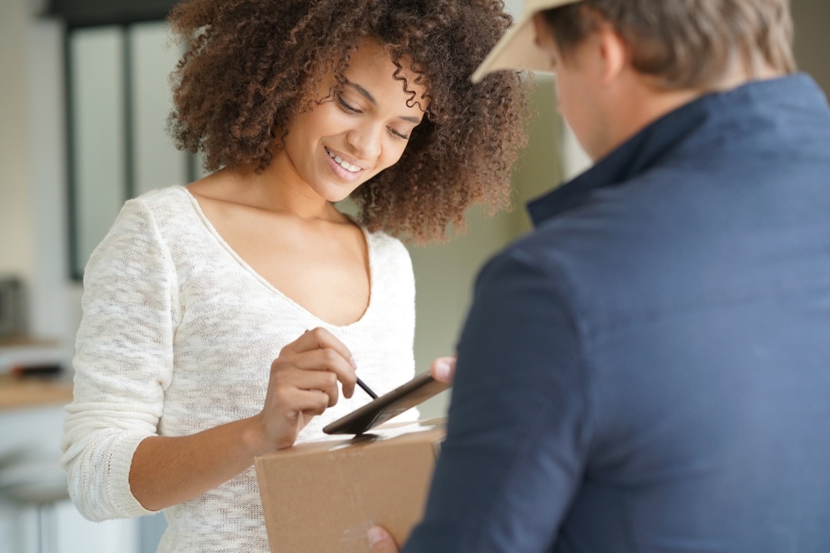 woman signing for a package