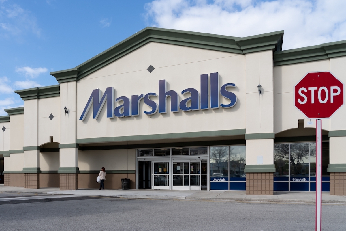 The exterior of a Marshalls store with a stop sign in the picture.