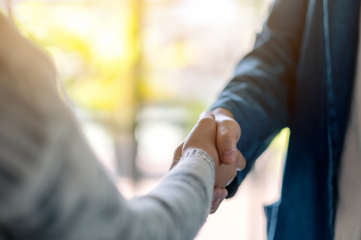 closeup of two adults shaking hands