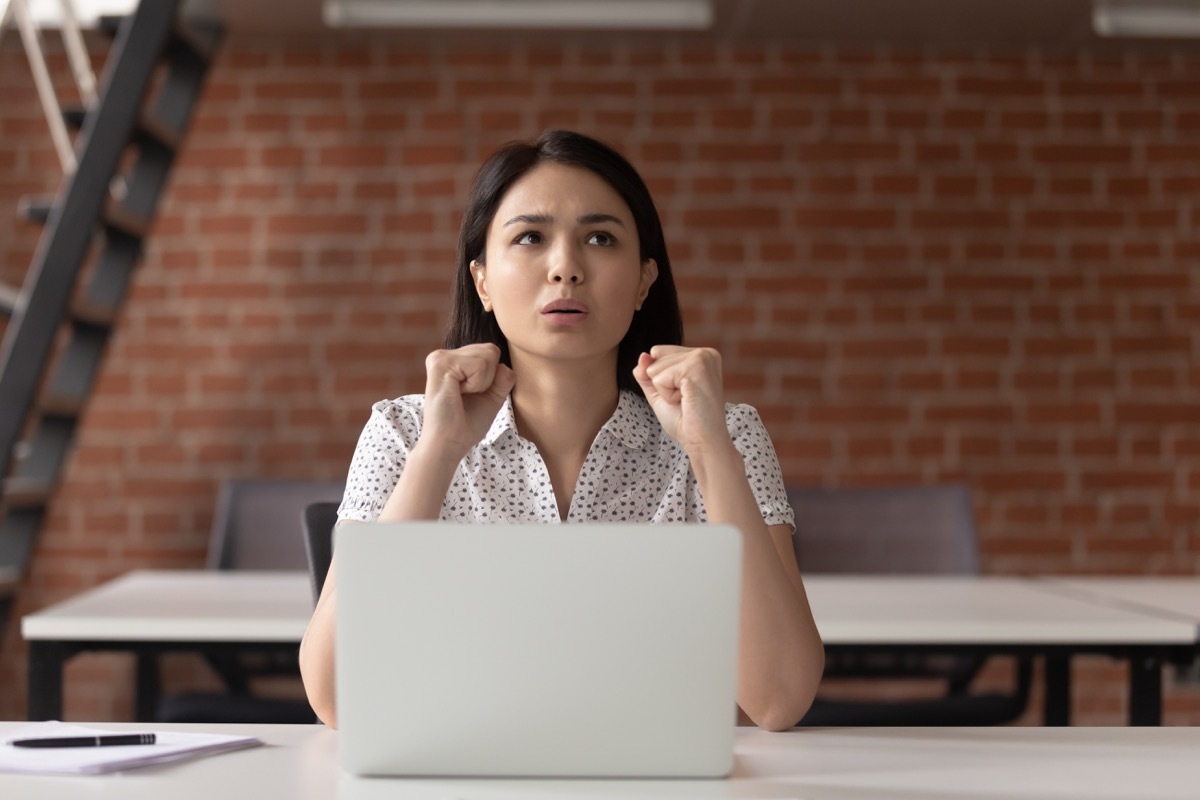 stressed woman sitting in front of laptop