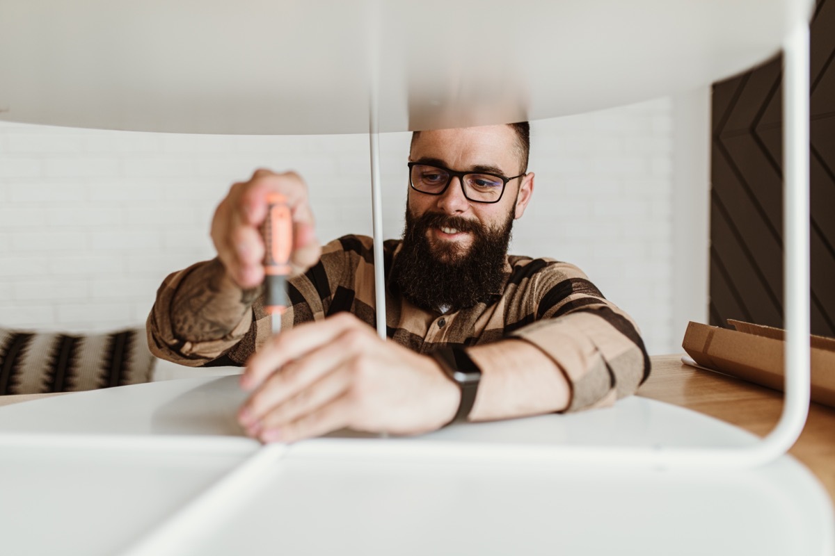 man assembling furniture