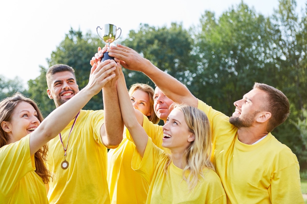 Team proudly holds their trophy high