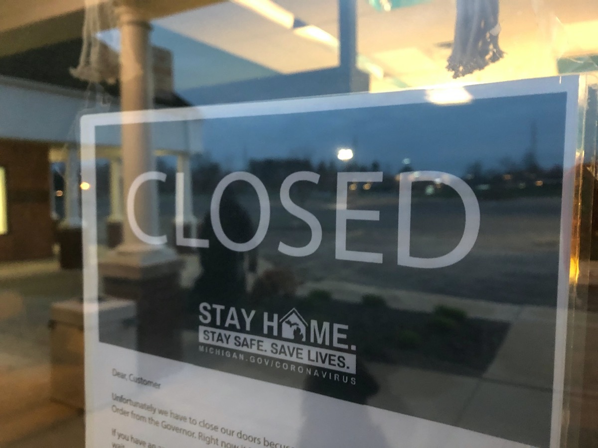 closed sign on door of michigan business