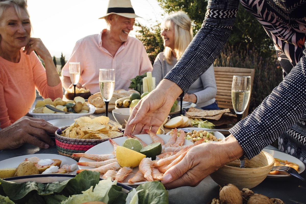 people eating outside, mediterranean food on table