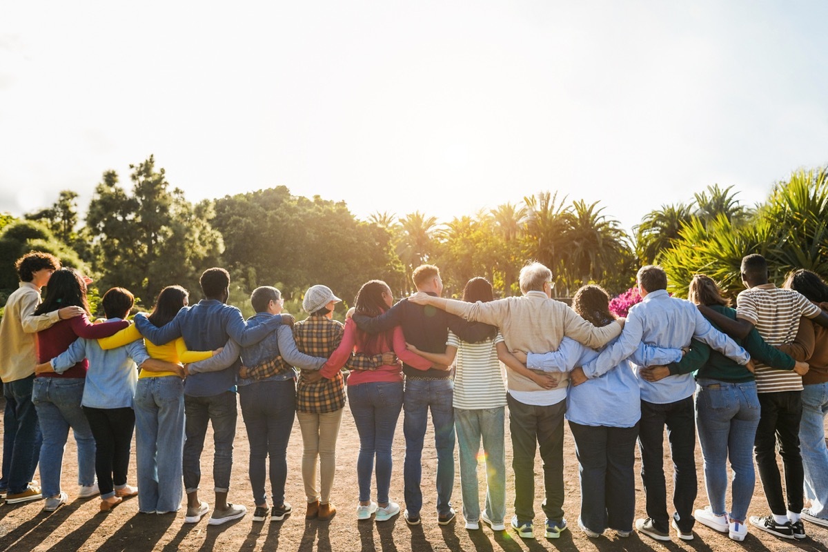 Group of multigenerational people hugging each others 