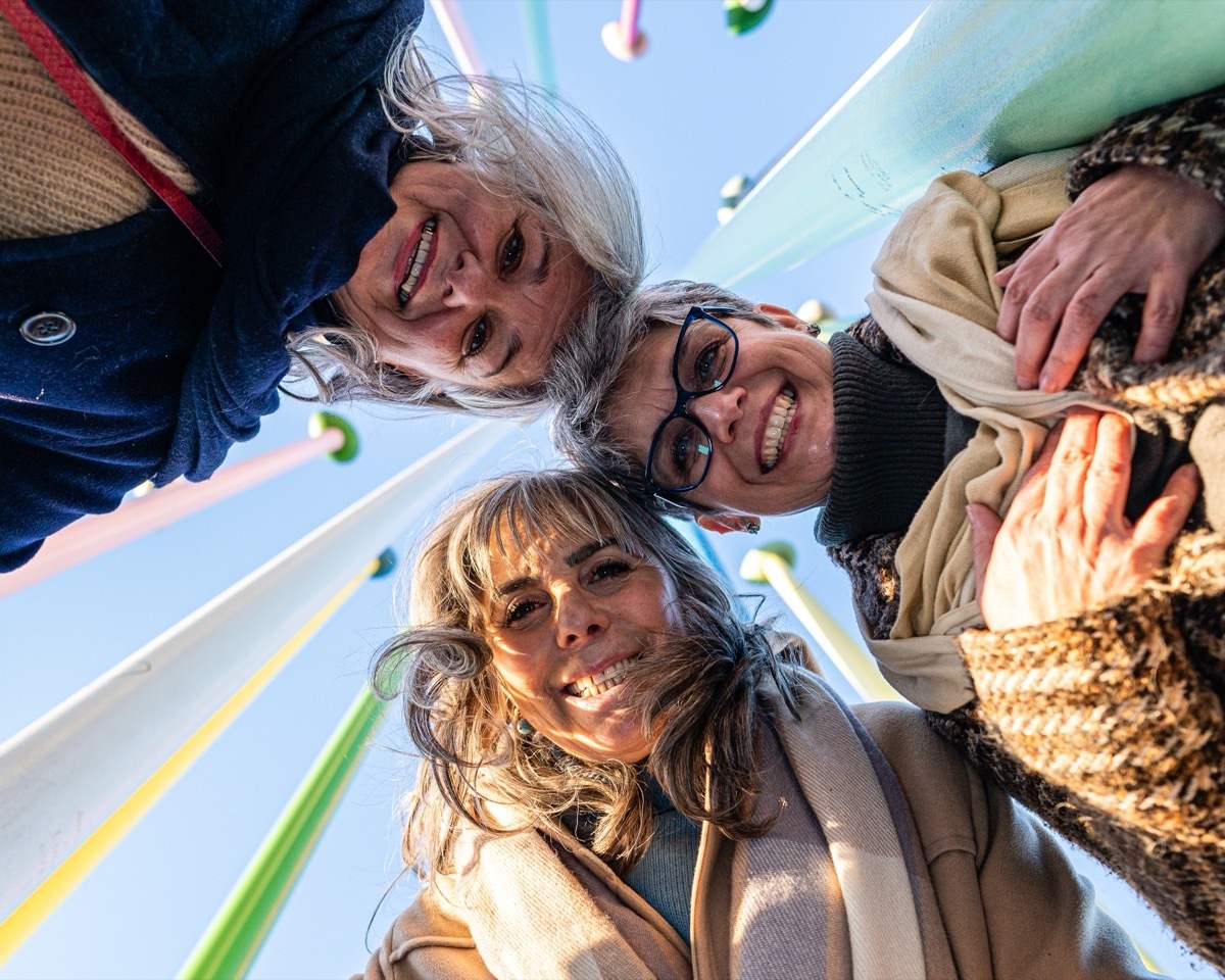 three women smiling down on the camera