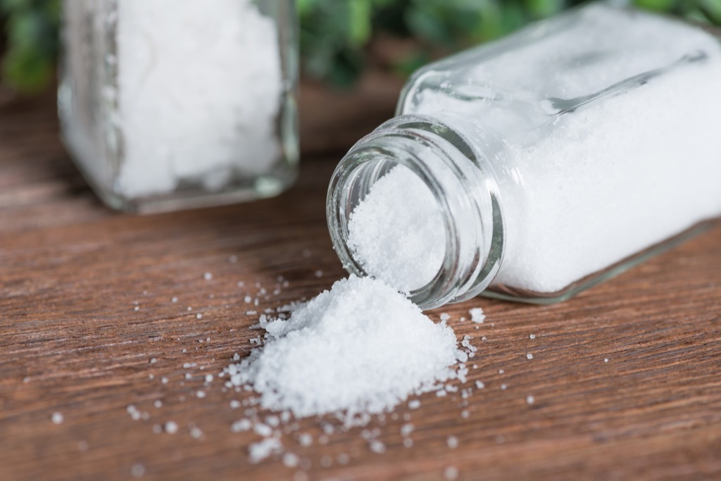 spilled salt shaker on wood table