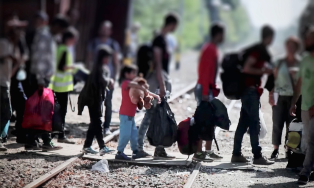 People crossing rails.