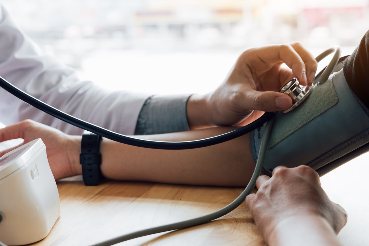 doctor takes patient's blood pressure