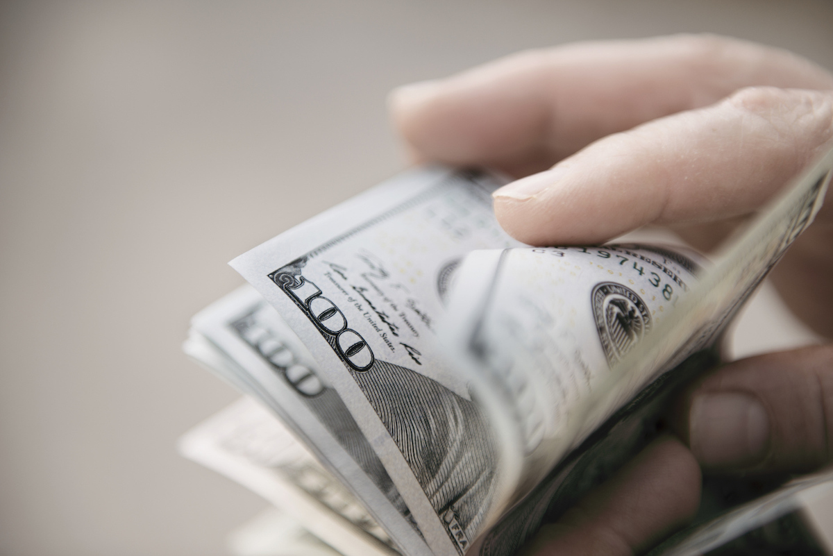 Unrecognizable mature man counting dollar bills