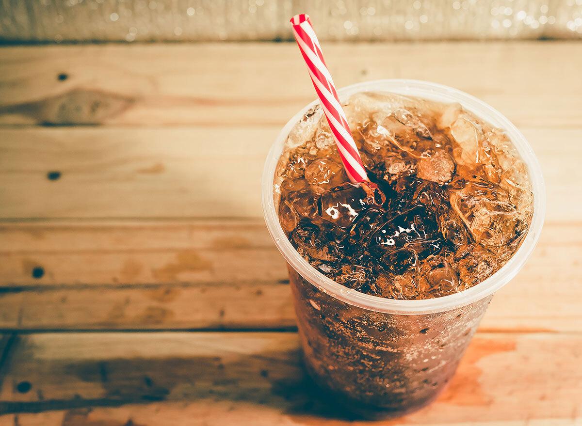 fountain soda with striped straw on wooden table