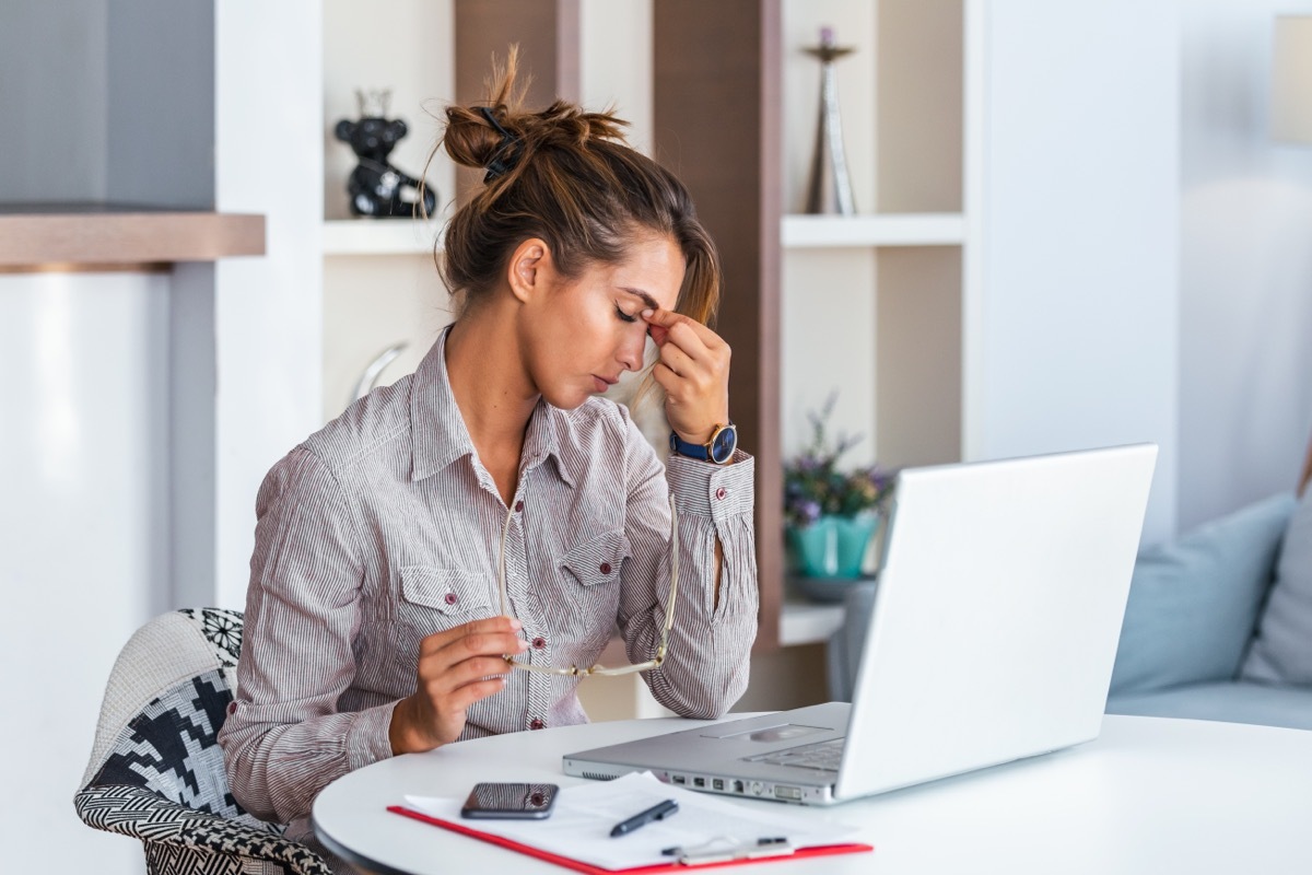 woman with tension headache sitting at desk