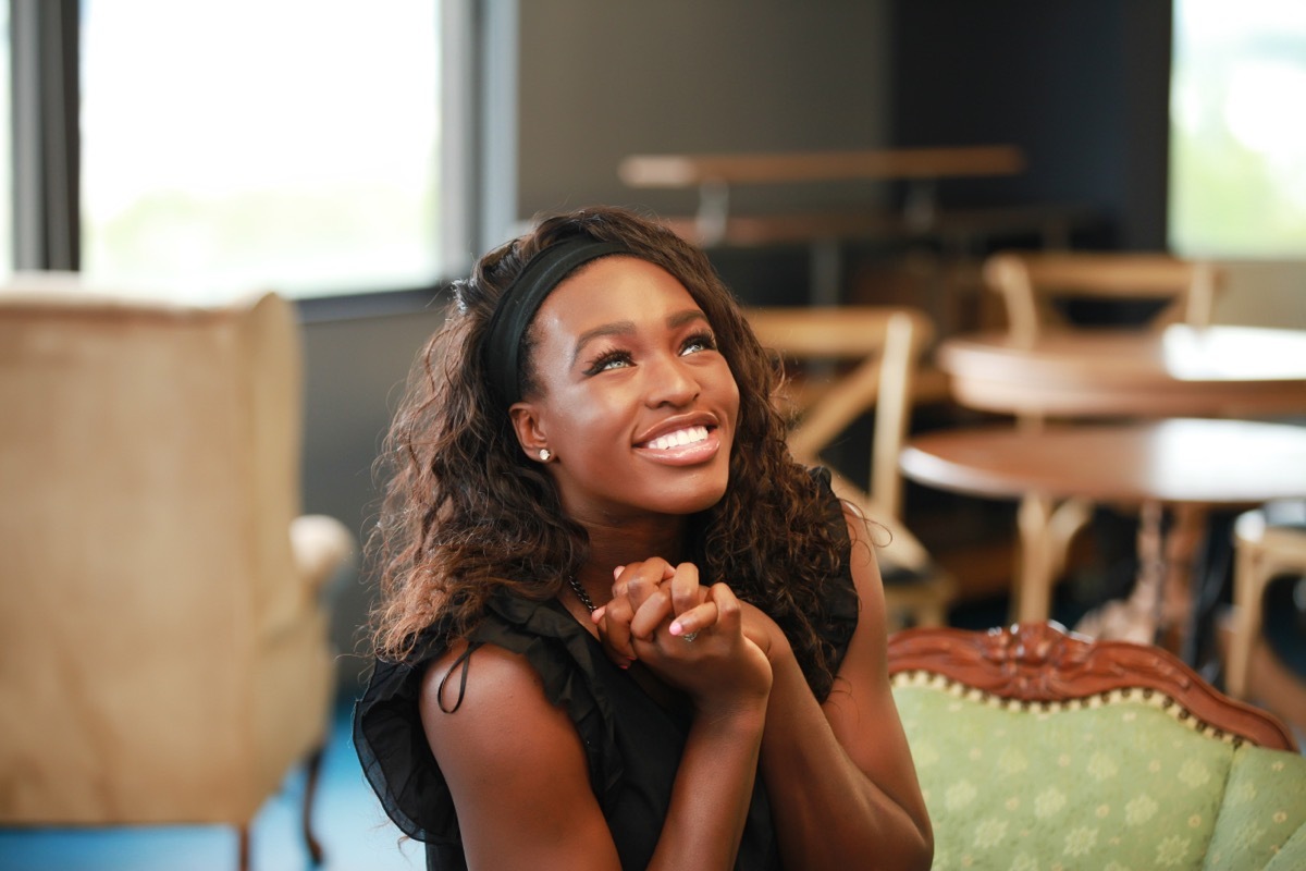 Woman extremely happy smiling.