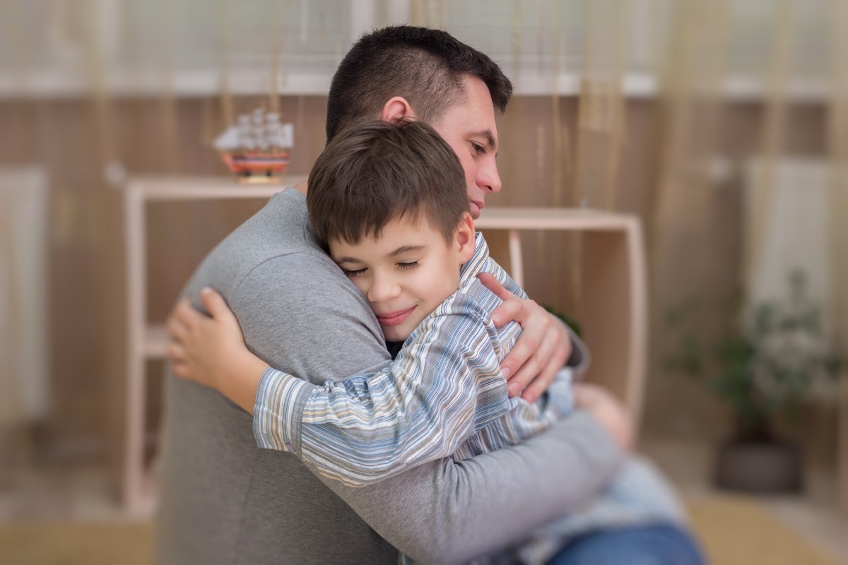 Father, son in emotional embrace of tears and joy