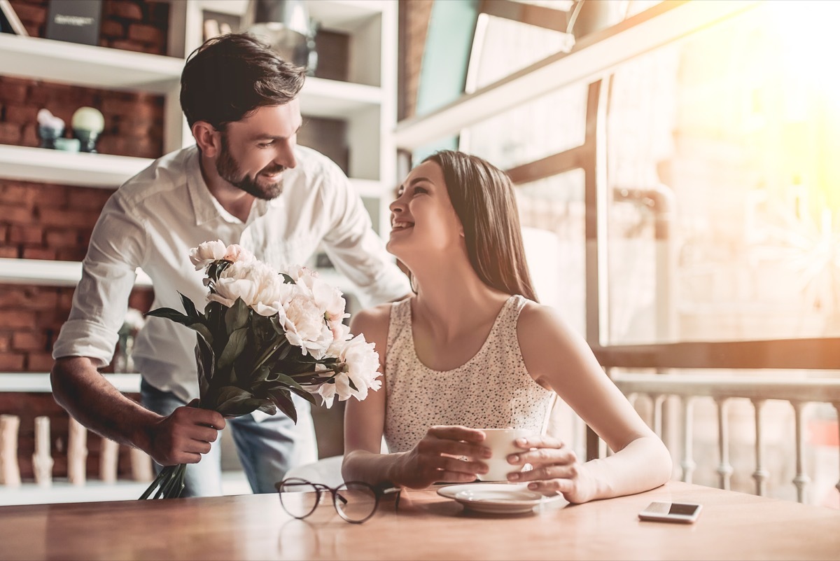 Man giving a woman flowers