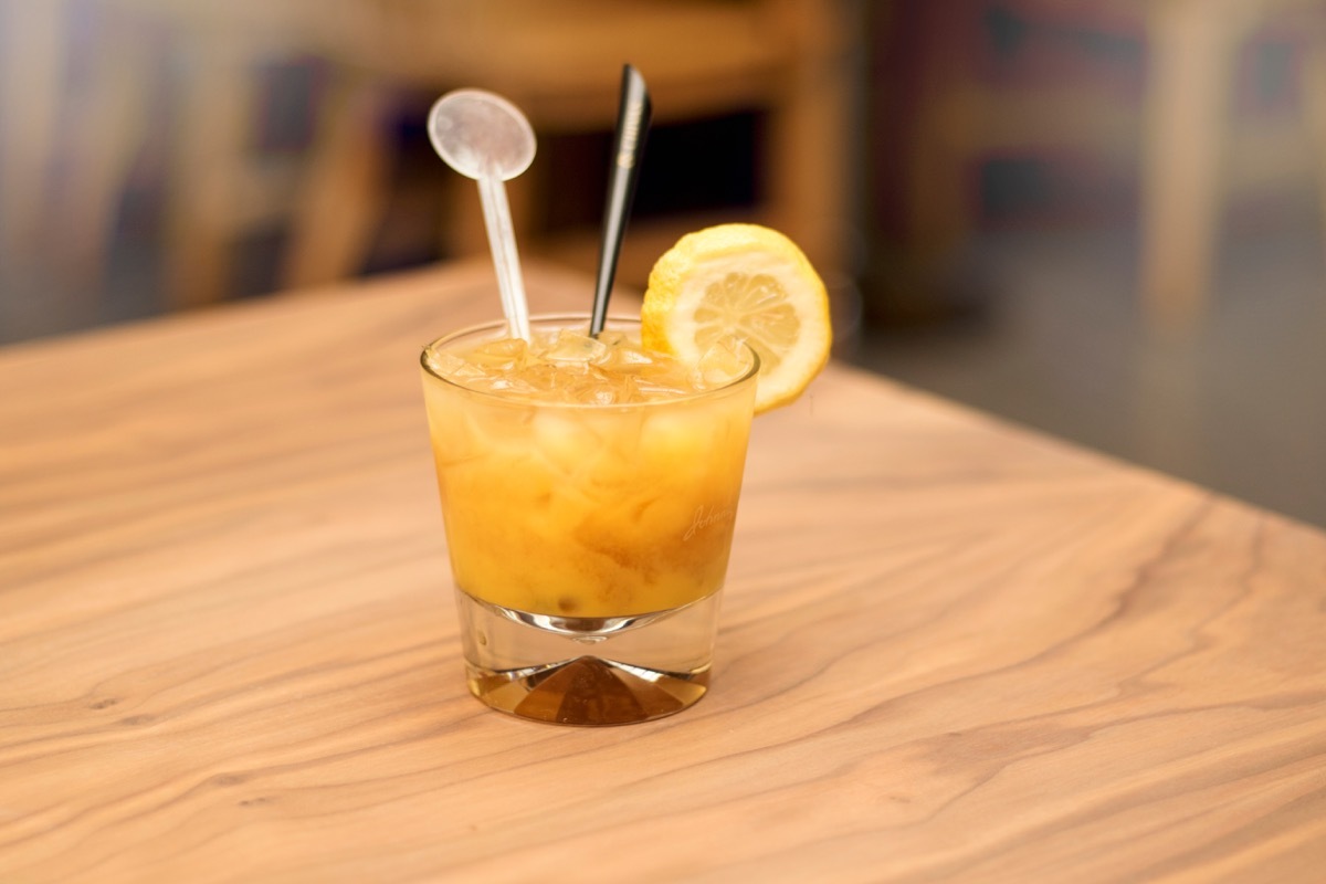 fuzzy navel cocktail on wooden table