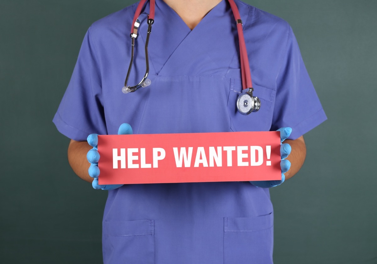 Doctor Holding a Sign 