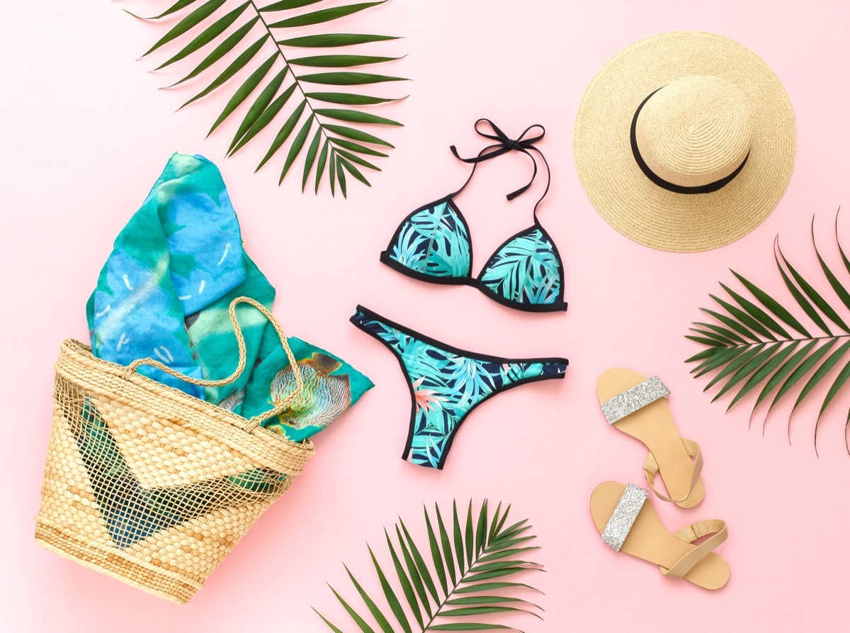 Bikini swimsuit with tropical print and other beach accessories.