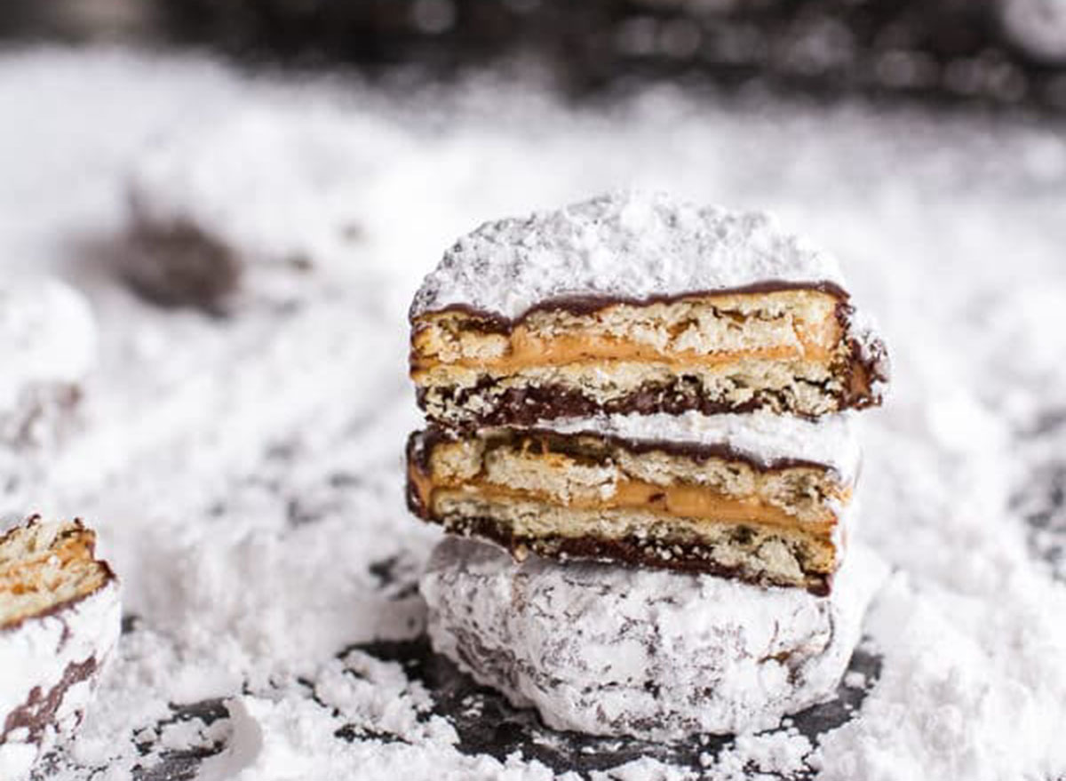 Puppy chow ritz cracker cookies on a bed of powdered sugar