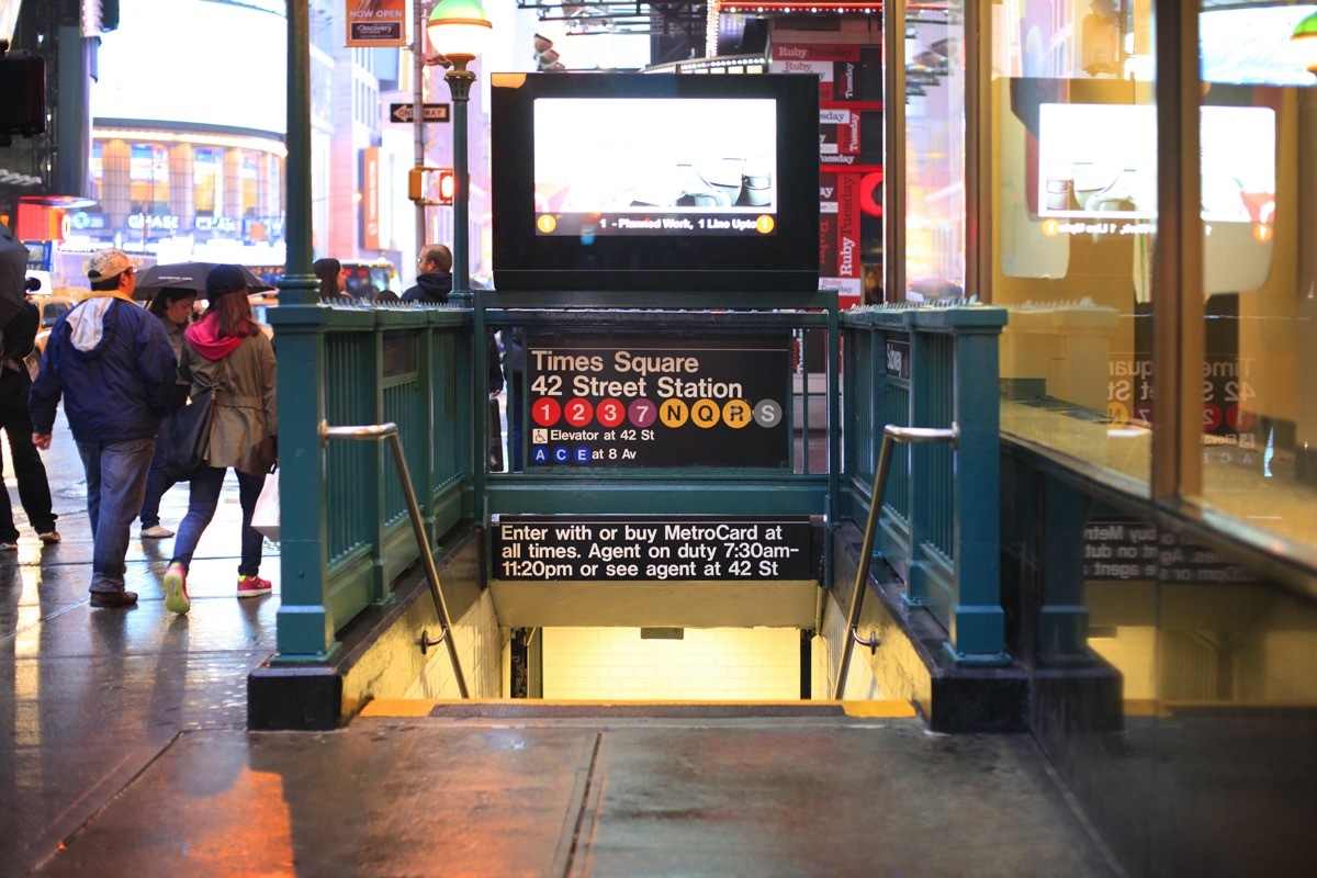 New York, New York, USA - May 20, 2013: An entrance to the Times Square 42nd Street Subway Station located on the corner of 7th Avenue and 40th street in New York City. Pedestrians can be seen. (New York, New York, USA - May 20, 2013: An entrance to t