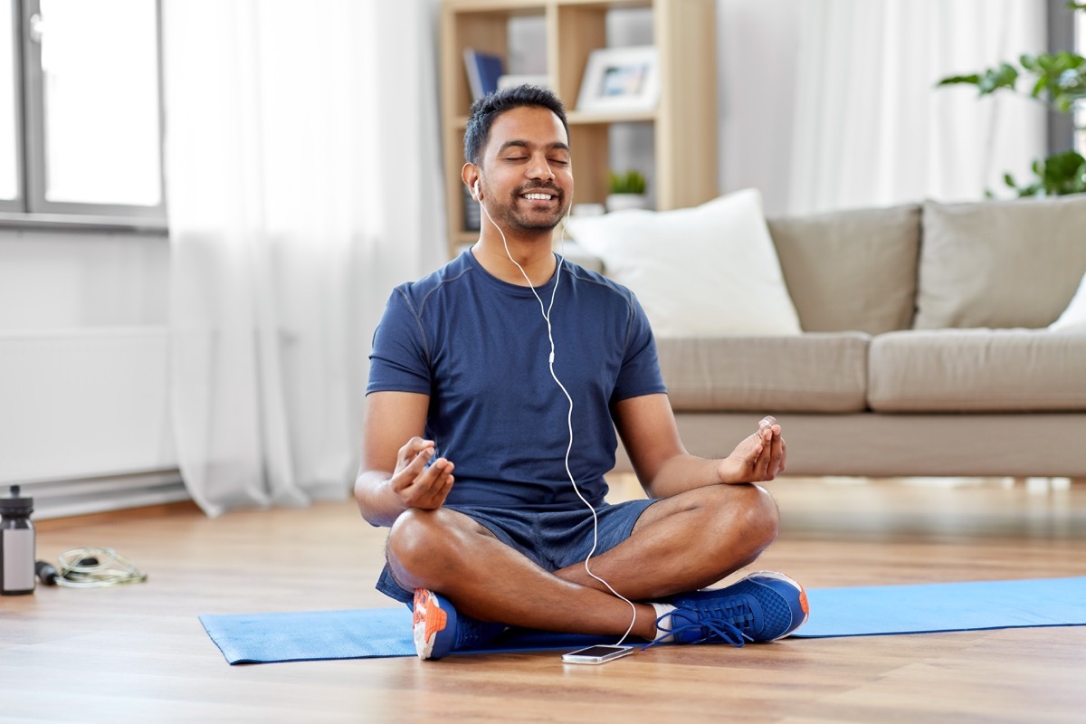 Man meditating with earphones