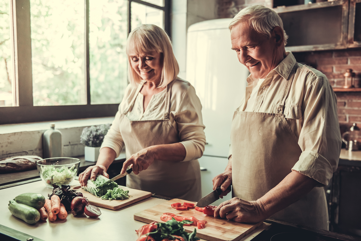 Older couple cooking vegetables 