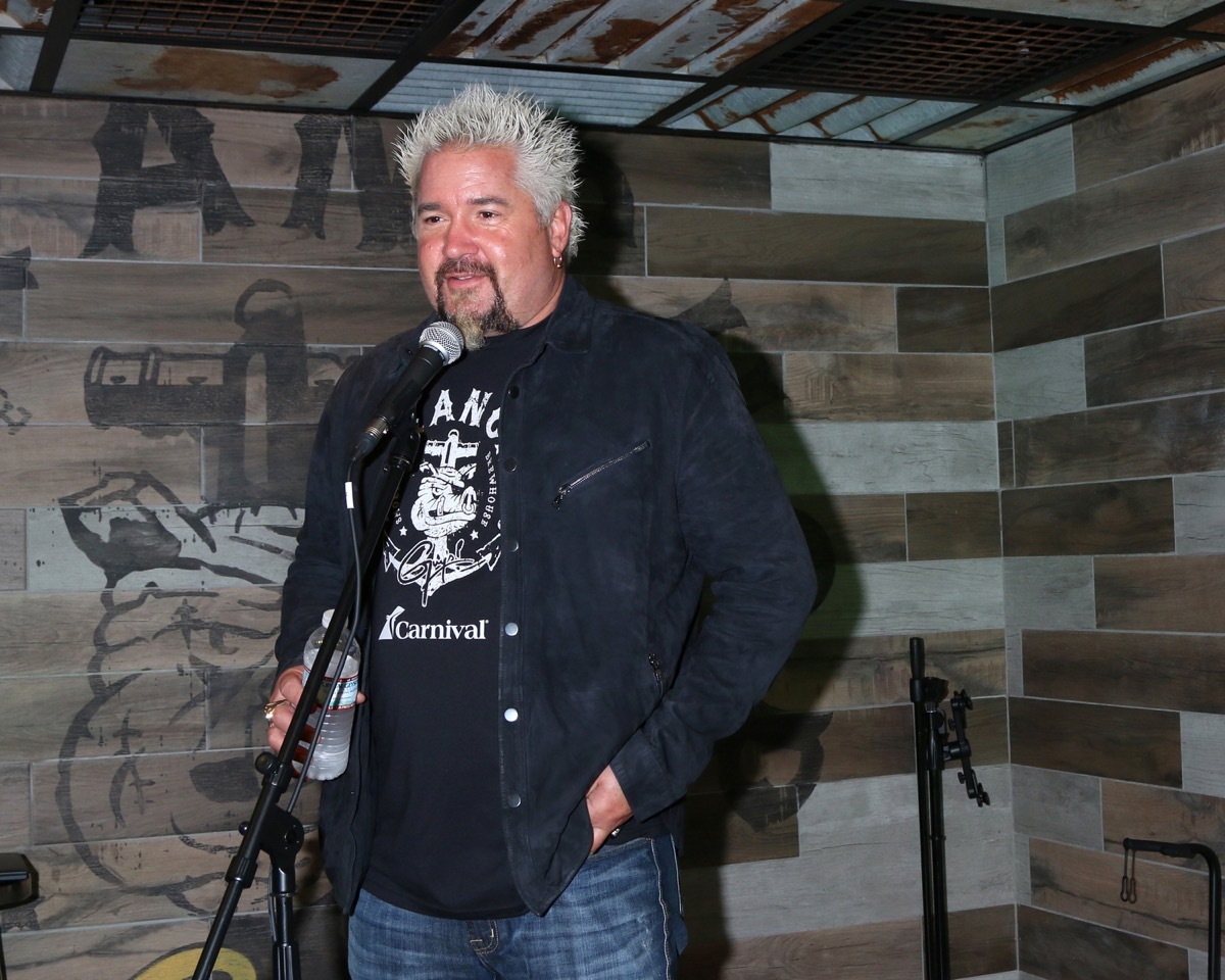 Guy Fieri speaking into the mic