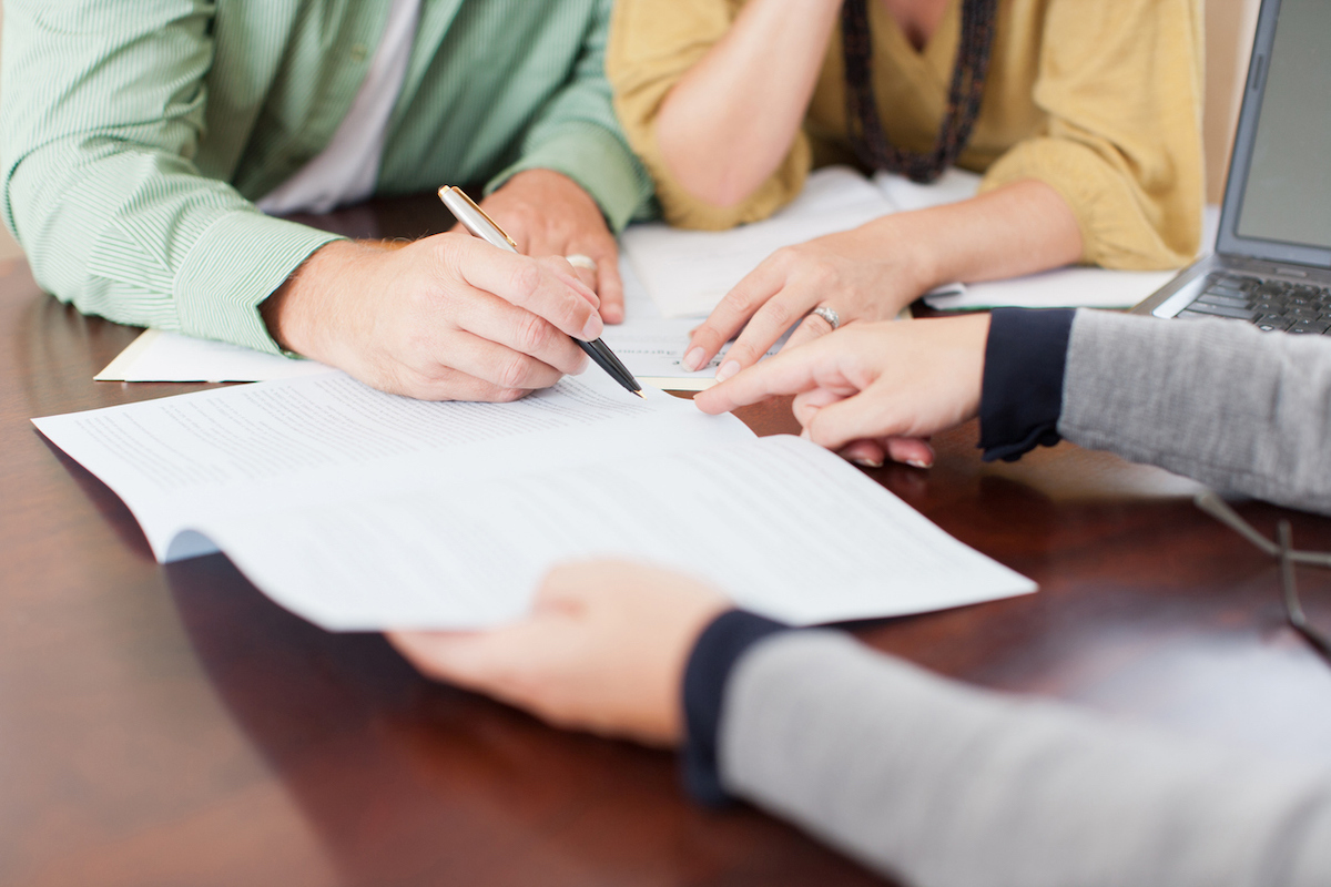 Couple signing home contract