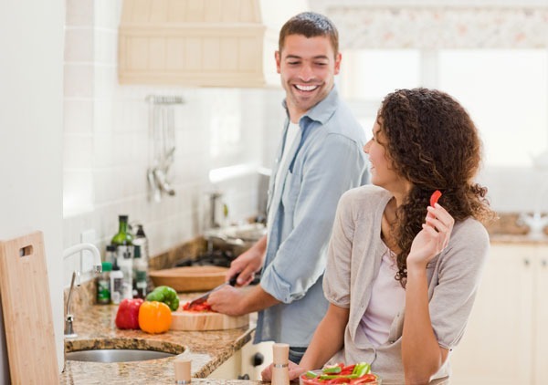 Two people cooking in house