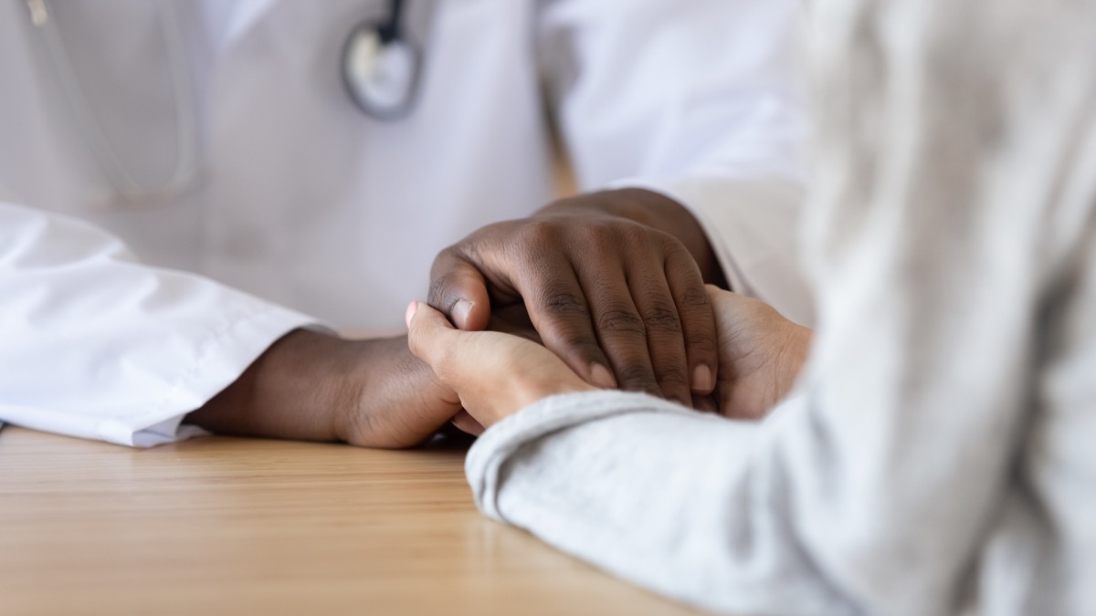 Doctor holding patient's hands