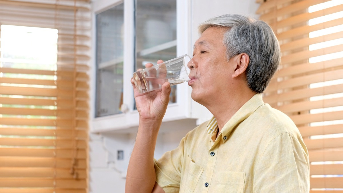 Older man drinking water