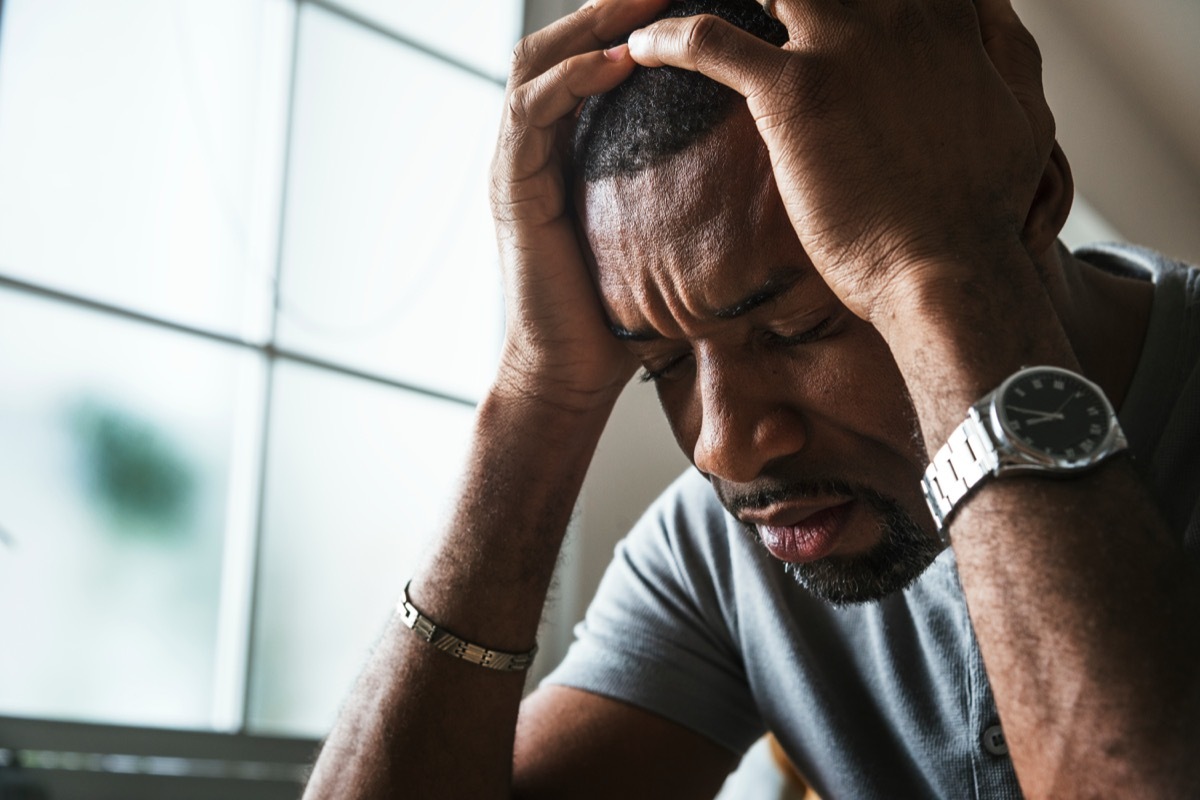 Distressed man head in hands