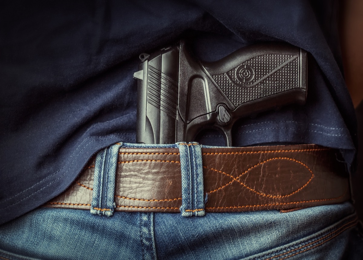 gun tucked into jeans