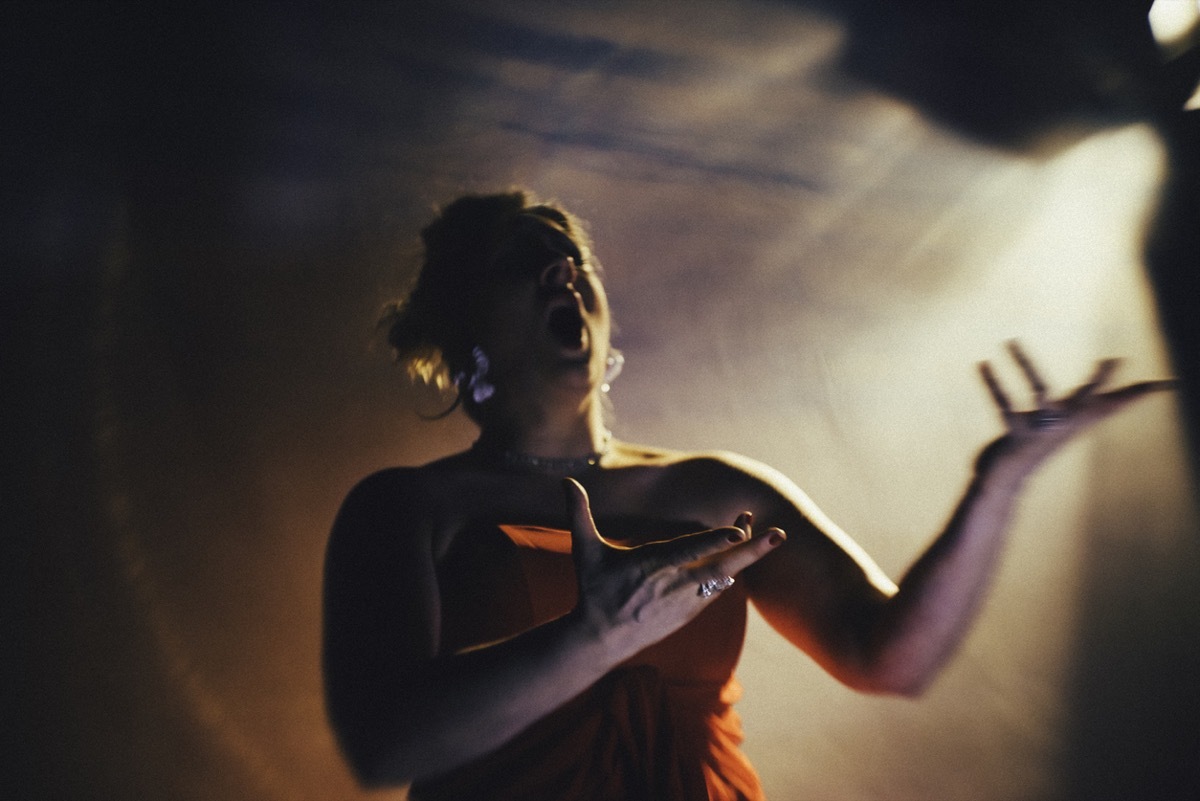 close up of white woman opera singer singing