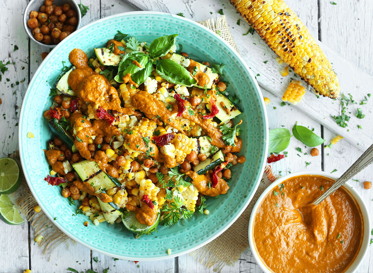 zucchini and grilled corn salad in bowl with salsa