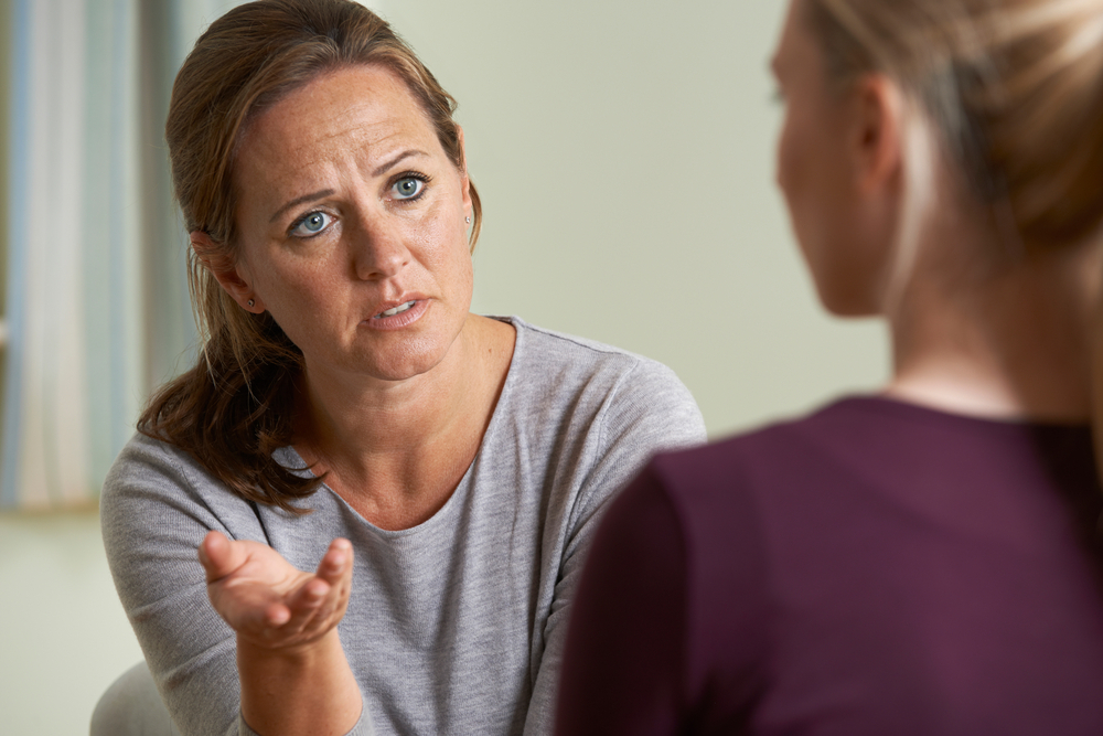 woman talking to another woman about big boobs