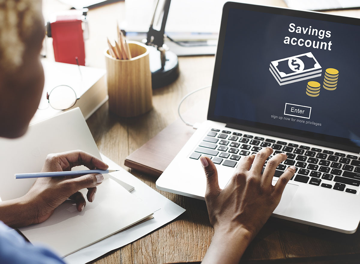 woman looking at savings account on laptop