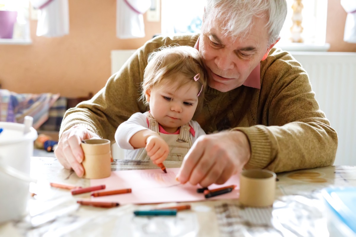 Grandfather drawing with baby granddaughter