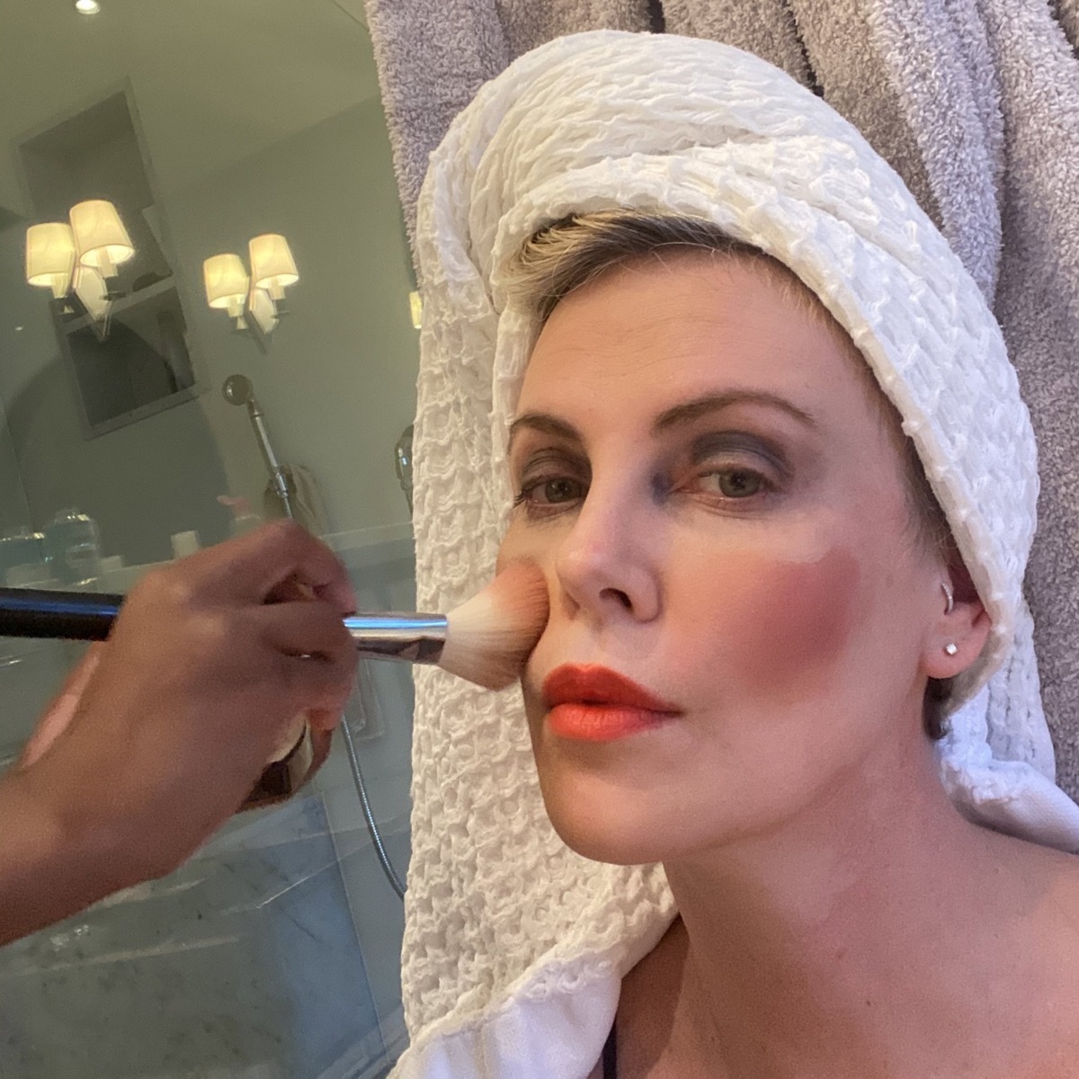 Charlize Theron having her makeup done by her daughter